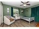 Colorful bedroom with hardwood floors, chair and whimsical decor at 2803 Joleen Dr, Eustis, FL 32726