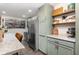 Modern kitchen featuring stainless steel appliances, decorative shelves, and a marble countertop at 2803 Joleen Dr, Eustis, FL 32726