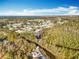 Panoramic aerial view of the community, featuring a winding canal, lush foliage, and waterfront homes at 3221 Myakka River Rd, Tavares, FL 32778