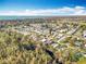 Aerial view of a serene lakeside community featuring lush greenery, waterfront property, and canals at 3221 Myakka River Rd, Tavares, FL 32778