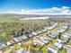 Expansive aerial view showcasing the community, nearby lake, and lush greenery at 3221 Myakka River Rd, Tavares, FL 32778