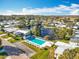 Aerial view of community with a pool, lake, landscaping, and rows of attractive residences at 3221 Myakka River Rd, Tavares, FL 32778