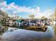 Boat dock is reflected in the lake and lined with multiple boats covered or ready for the water at 3221 Myakka River Rd, Tavares, FL 32778