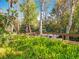 Private dock featuring a boat on the water, with lush green foliage surrounding the peaceful canal at 3221 Myakka River Rd, Tavares, FL 32778