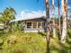 A grey house is seen from outside at 3221 Myakka River Rd, Tavares, FL 32778