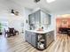 Transitional kitchen area with gray cabinetry, white countertops and connection to other living spaces at 3221 Myakka River Rd, Tavares, FL 32778