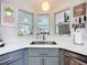 Modern kitchen sink with bright white countertops, modern faucet, and ample natural light at 3221 Myakka River Rd, Tavares, FL 32778