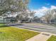 The property features shuffleboard courts with covered seating, lush green landscaping, and walking path at 3221 Myakka River Rd, Tavares, FL 32778