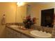 Bathroom with double sinks, granite countertop, and decorative accents at 3290 Sennett Cir, Oxford, FL 34484