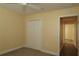 Bright bedroom with neutral walls, carpet, and double closet at 3290 Sennett Cir, Oxford, FL 34484