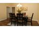 Well-staged dining room features seating for six, warm lighting, and elegant décor at 3290 Sennett Cir, Oxford, FL 34484