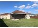 Exterior view of the house highlighting the screened lanai and landscaping at 3290 Sennett Cir, Oxford, FL 34484