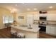 Eat-in kitchen featuring a stainless steel oven, island with seating, and plentiful white cabinets at 3290 Sennett Cir, Oxford, FL 34484