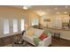 Inviting living room features wood floors, neutral walls, modern furnishings, and light from the double doors at 3290 Sennett Cir, Oxford, FL 34484