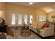 Bright living room featuring a comfortable sofa, stylish rug, and glass coffee table at 3290 Sennett Cir, Oxford, FL 34484