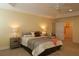 Main bedroom with a ceiling fan, tray ceiling, and ample space at 3290 Sennett Cir, Oxford, FL 34484