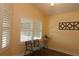 Inviting sitting area with natural light, plantation shutters, and seating for two at 3290 Sennett Cir, Oxford, FL 34484