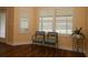 Cozy sitting area with bright windows and shutters and comfortable seating for two at 3290 Sennett Cir, Oxford, FL 34484