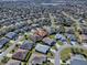 Aerial view of a community neighborhood and single Gathering home featuring mature landscaping at 3330 Mayflower Loop, The Villages, FL 32163