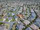 Aerial view of a community neighborhood and single Gathering home featuring mature landscaping at 3330 Mayflower Loop, The Villages, FL 32163