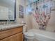 Bright bathroom featuring a shower-tub combo with decorative curtain and vanity with granite countertop at 3330 Mayflower Loop, The Villages, FL 32163