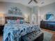 Bedroom featuring hardwood floors, bright windows, and stylish decor at 3330 Mayflower Loop, The Villages, FL 32163