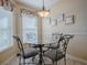 Cozy dining area featuring a glass-top table, wrought iron chairs, and bright natural light at 3330 Mayflower Loop, The Villages, FL 32163