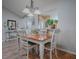 Bright dining room featuring a wood table with white accents, hardwood floors, and decorative lighting at 3330 Mayflower Loop, The Villages, FL 32163