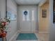 Inviting entryway featuring a white front door, a neutral color scheme, and stylish decor at 3330 Mayflower Loop, The Villages, FL 32163