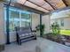 Covered patio with bench seating, plants and natural light at 3330 Mayflower Loop, The Villages, FL 32163