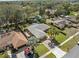 Stunning home showcasing a brick driveway, lush green lawn, and mature palm trees at 3400 Foxboro Ct, Mount Dora, FL 32757