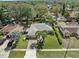 Aerial shot of the home with a well-manicured lawn and lush landscaping at 3400 Foxboro Ct, Mount Dora, FL 32757