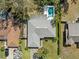 An aerial view showcasing the property, landscaping, and private pool at 3400 Foxboro Ct, Mount Dora, FL 32757