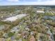 Aerial view showing the neighborhood with nearby shopping centers and lake at 3400 Foxboro Ct, Mount Dora, FL 32757