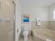 Cozy bathroom featuring tiled shower, toilet, and tiled garden tub with neutral countertops and decor at 3400 Foxboro Ct, Mount Dora, FL 32757