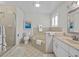 Bright bathroom featuring a shower, garden tub, and vanity with neutral color palette and beachy decor at 3400 Foxboro Ct, Mount Dora, FL 32757