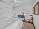 Bright bedroom with white bedding, hardwood floors, and a vintage turquoise accent table at 3400 Foxboro Ct, Mount Dora, FL 32757