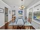 Bright dining room featuring a glass table, wooden chairs, and an elegant chandelier at 3400 Foxboro Ct, Mount Dora, FL 32757