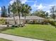 Beautiful home featuring a brick driveway, landscaped yard, and mature palm trees at 3400 Foxboro Ct, Mount Dora, FL 32757
