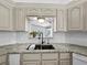 Beautiful kitchen with sleek white subway tile, granite counters, and stainless steel appliances at 3400 Foxboro Ct, Mount Dora, FL 32757