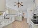 Bright and airy kitchen with granite countertops, white cabinets, and stainless steel appliances at 3400 Foxboro Ct, Mount Dora, FL 32757