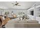 Bright living room featuring built-in shelving, French doors, and comfortable seating at 3400 Foxboro Ct, Mount Dora, FL 32757