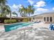 A beautiful pool area surrounded by lush tropical landscaping and a privacy fence at 3400 Foxboro Ct, Mount Dora, FL 32757