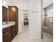 Bathroom featuring dark wood cabinetry, granite countertops, and a tiled walk-in shower at 3540 O'Brien Pl, The Villages, FL 32163