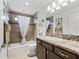 Comfortable bathroom featuring a shower and tub, stylish vanity, and tiled floors at 3540 O'Brien Pl, The Villages, FL 32163