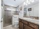 Well-lit bathroom featuring a glass enclosed shower, stylish vanity, and tiled floors at 3540 O'Brien Pl, The Villages, FL 32163