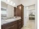 Bathroom featuring dark wood vanity, granite countertops, and walk-in shower at 3540 O'Brien Pl, The Villages, FL 32163