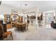 Dining area connected to the kitchen with bar seating and entryway in the background at 3540 O'Brien Pl, The Villages, FL 32163