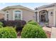 Inviting entrance with landscaped garden, covered porch, and elegant front door at 3540 O'Brien Pl, The Villages, FL 32163