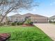 Well-kept home exterior boasting a manicured lawn, lush landscaping, and a convenient two-car garage at 3540 O'Brien Pl, The Villages, FL 32163